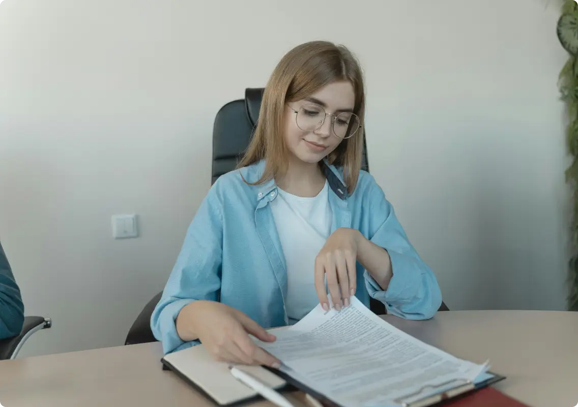 Young professional reviewing documents at desk