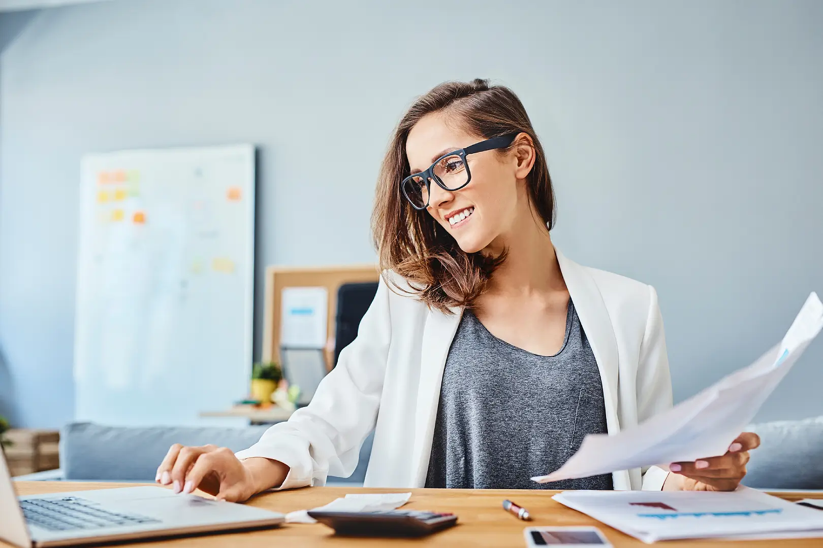 Smiling woman organizing paperwork